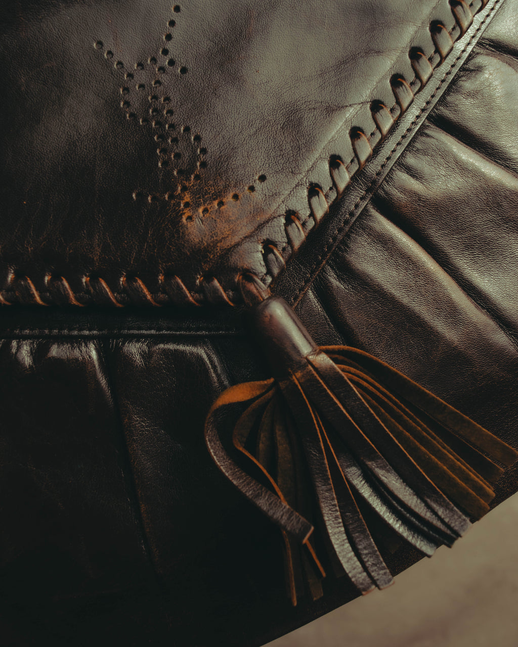 “Yves Saint Laurent” 70’s-80’s Perforated logo leather tassel shoulder bag