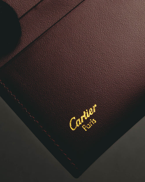 “Cartier” 90’s Must de Cartier burgundy embossed leather bifold wallet