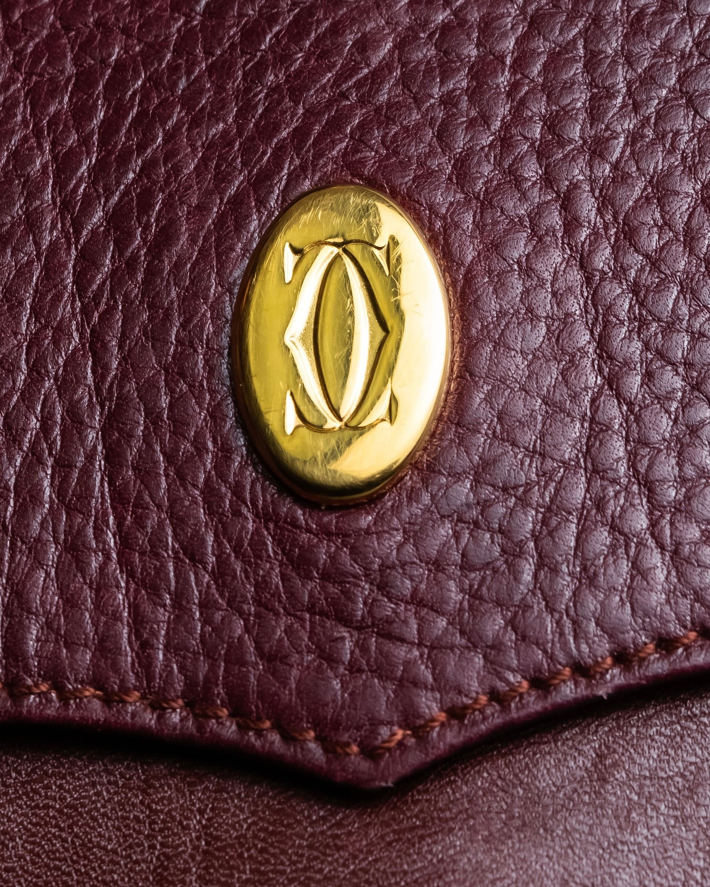 "Cartier" Texture changing bordeaux colored leather shoulder bag