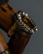 "Alexandar McQueen" Horseshoe motif red stone top ring