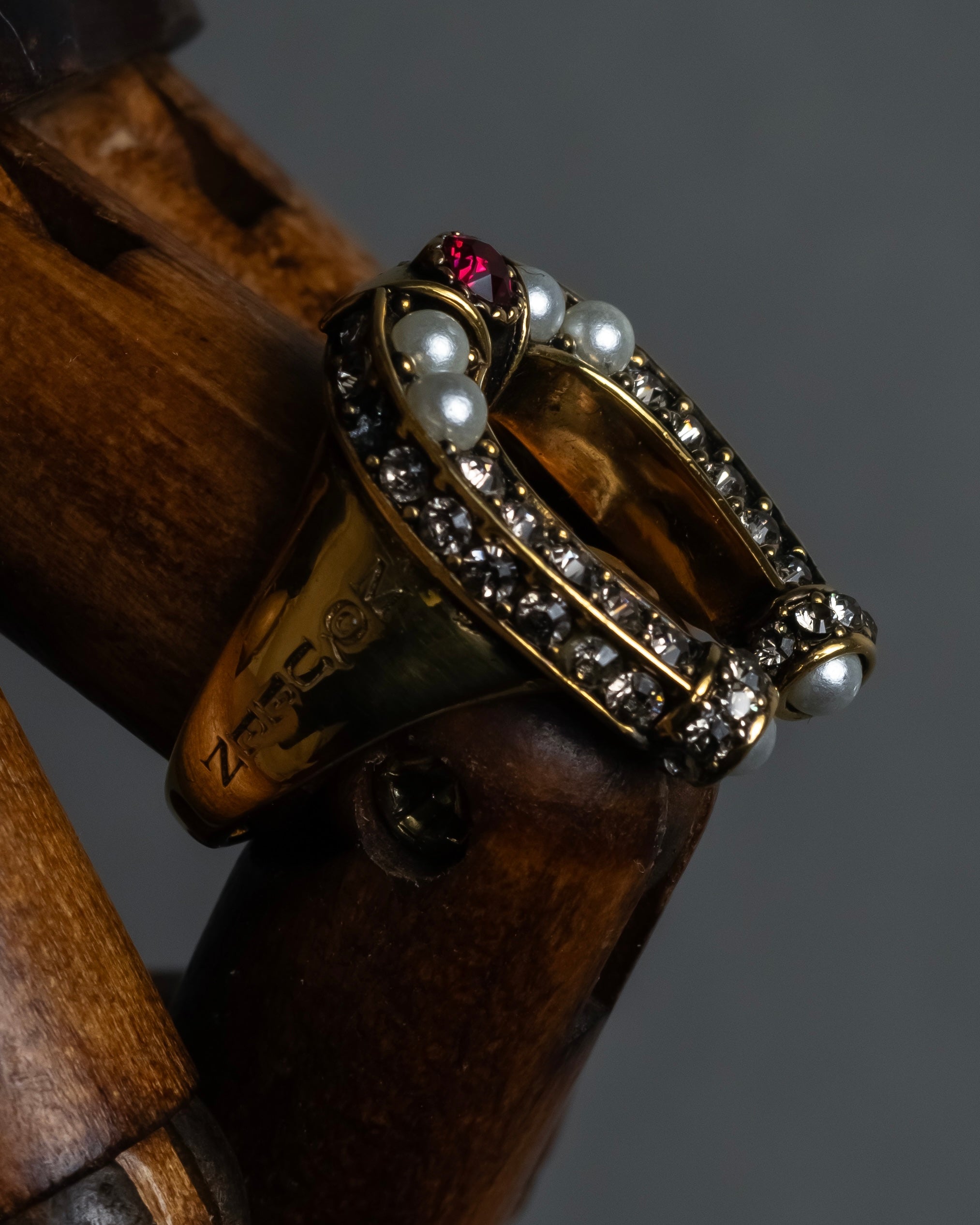 "Alexandar McQueen" Horseshoe motif red stone top ring