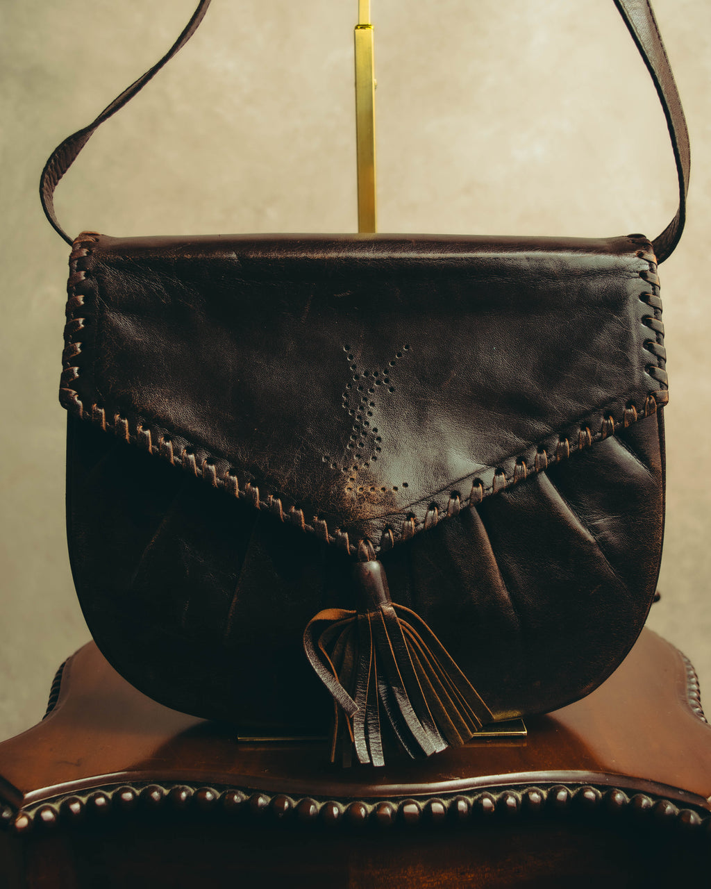“Yves Saint Laurent” 70’s-80’s Perforated logo leather tassel shoulder bag