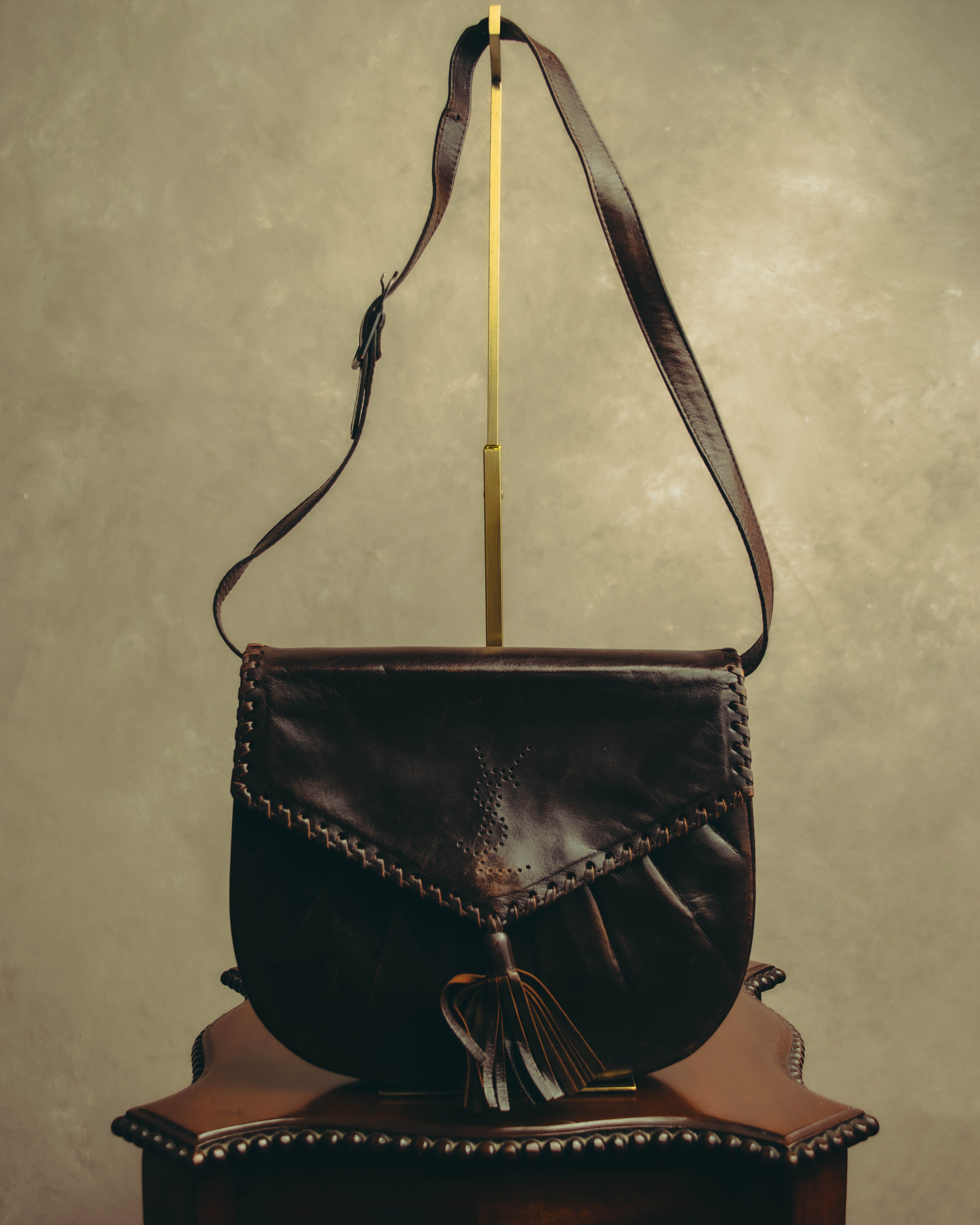 “Yves Saint Laurent” 70’s-80’s Perforated logo leather tassel shoulder bag
