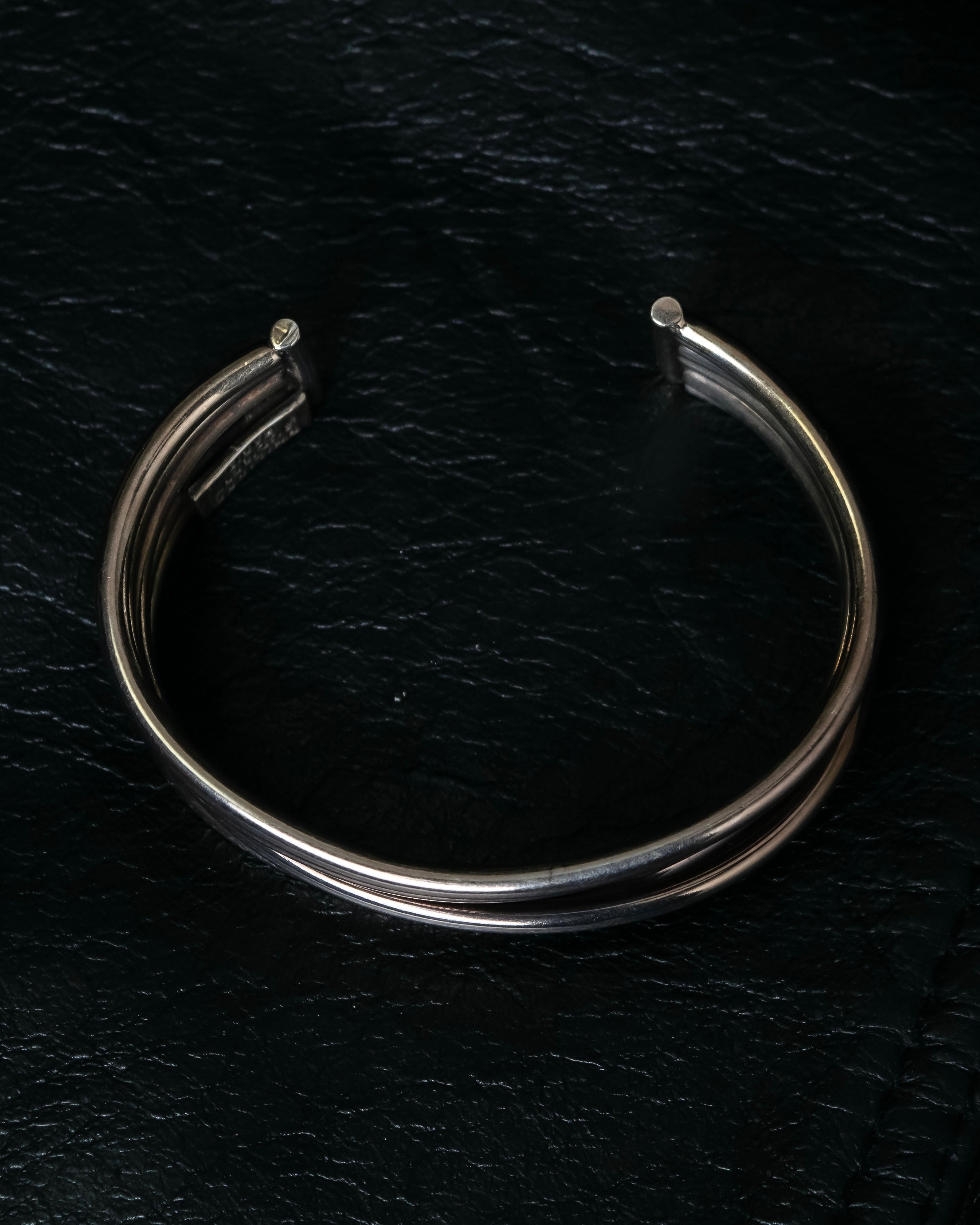 “PHILIPPE AUDIBERT” Crossed 5 line silver bangle