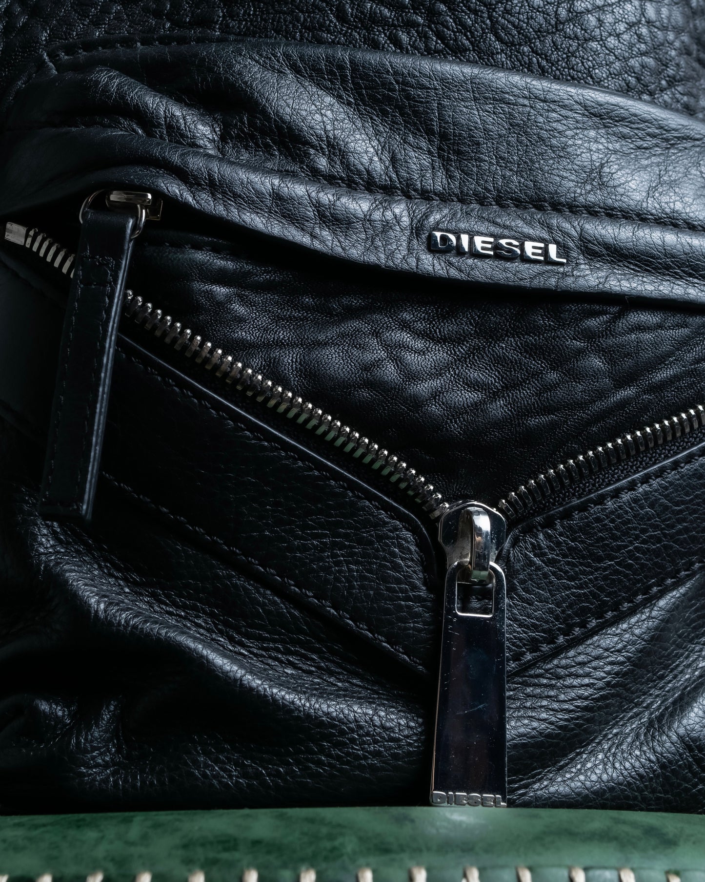 "DIESEL" Decorative zip design leather backpack