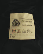 NEW WOOL 100%表記と旧式の日本語取扱絵表示が確認できる、内側の品質表示タグ。表記サイズはM。