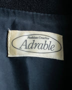 Tight-waisted wool shirt and black coat