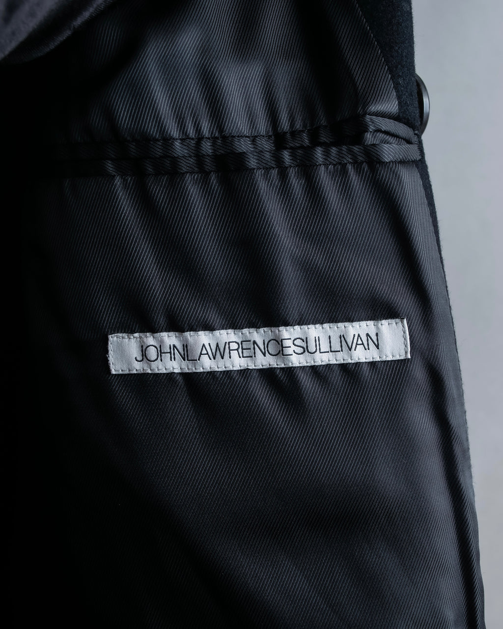 "JOHN LAWRENCE SULLIVAN"
 Large lapel double-breasted mid length coat