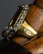 "Alexandar McQueen" Horseshoe motif red stone top ring