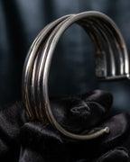 “PHILIPPE AUDIBERT” Crossed 5 line silver bangle