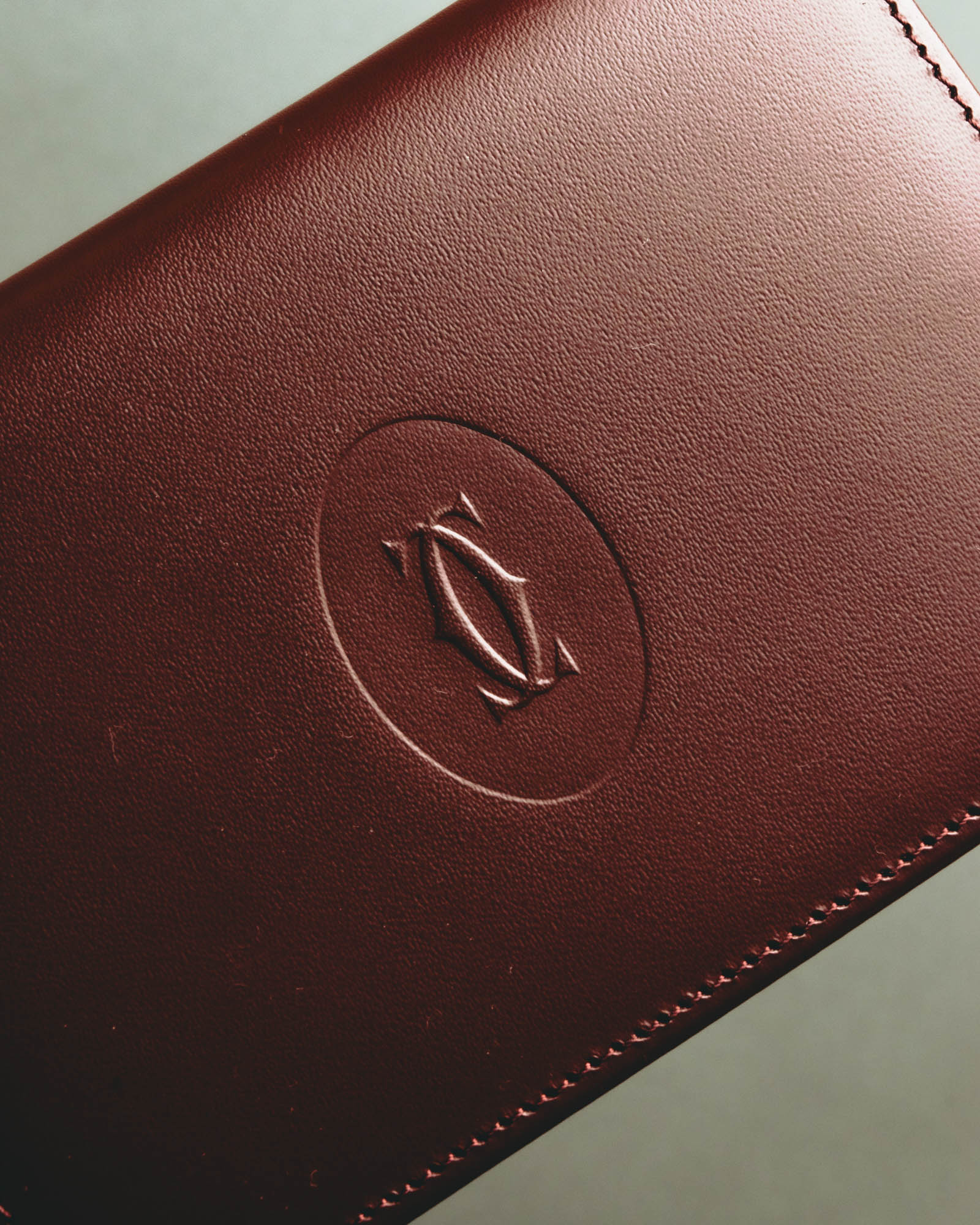 “Cartier” 90’s Must de Cartier burgundy embossed leather bifold wallet