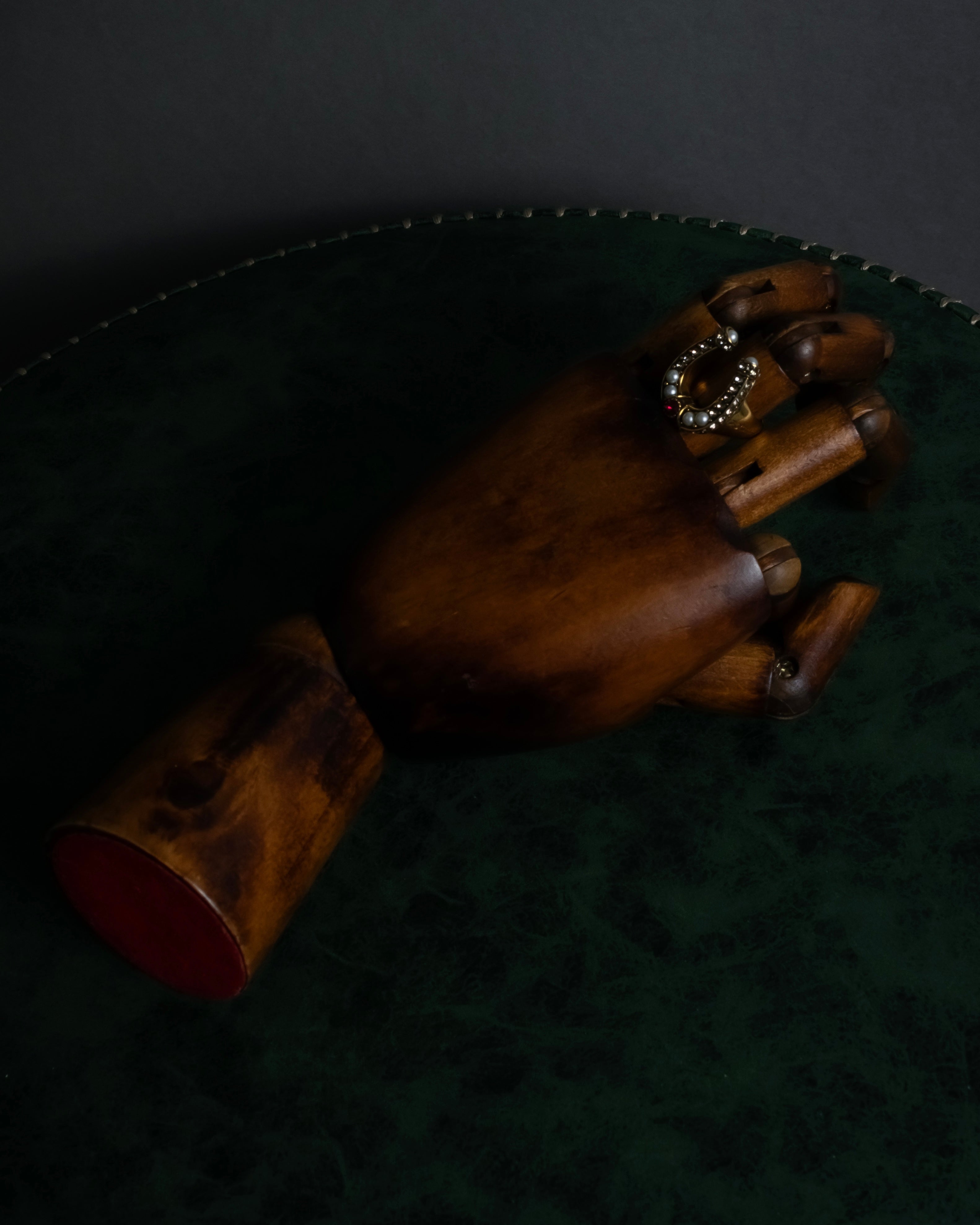 "Alexandar McQueen" Horseshoe motif red stone top ring