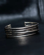 “PHILIPPE AUDIBERT” Crossed 5 line silver bangle
