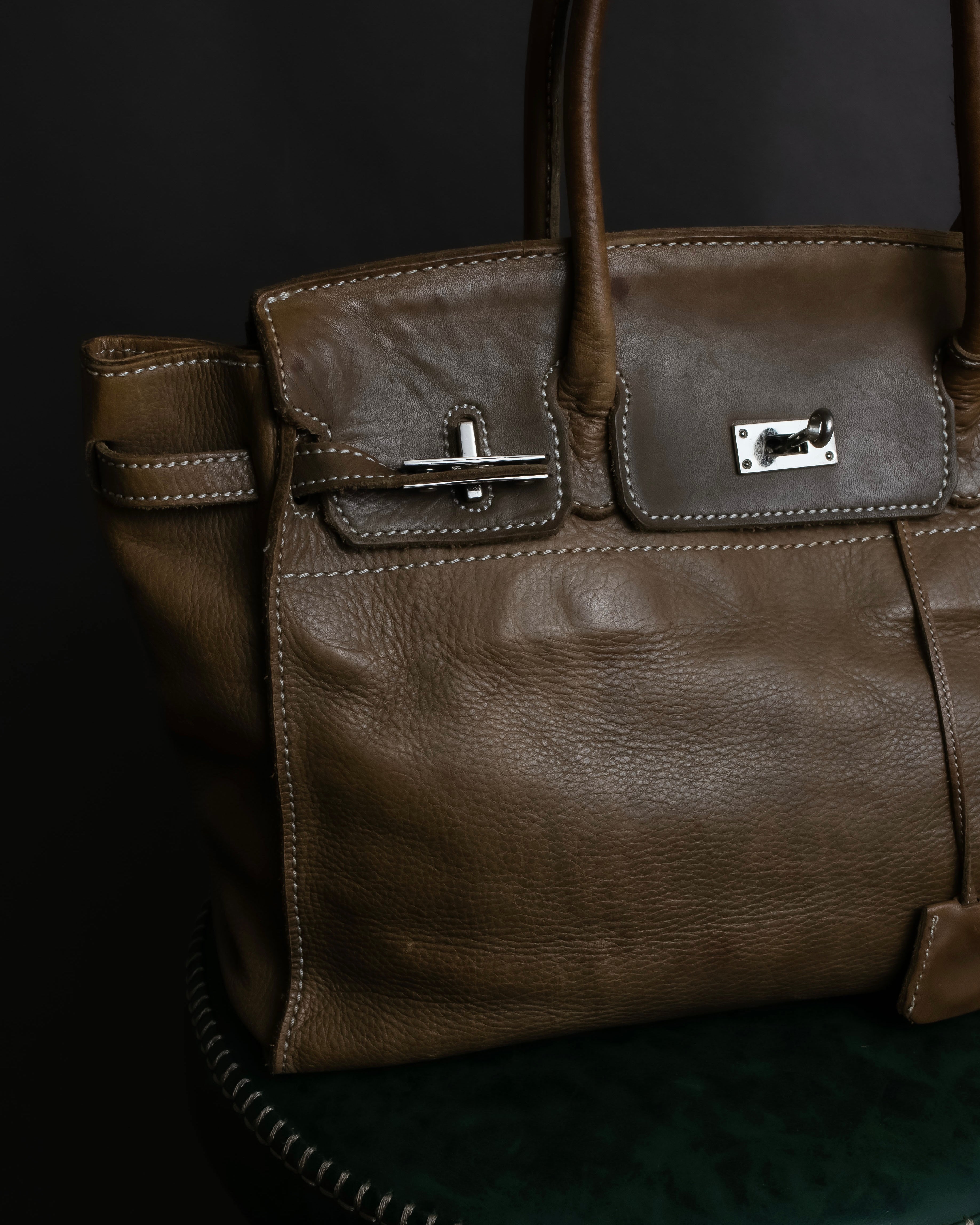 "Mademoiselle Accessories"
 Silver parts design leather one handle bag