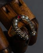 "Alexandar McQueen" Horseshoe motif red stone top ring
