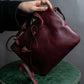 "Cartier" Texture changing bordeaux colored leather shoulder bag