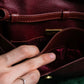 "Cartier" Texture changing bordeaux colored leather shoulder bag