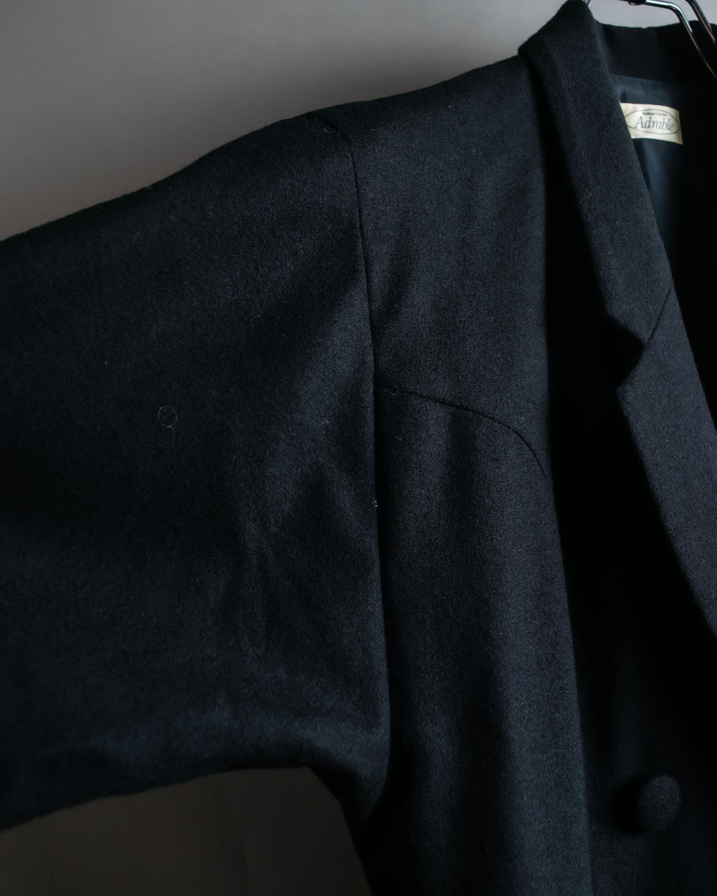 Tight-waisted wool shirt and black coat