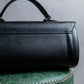 "BURBERRYS" Cylindrical design logo engraved leather one handle bag