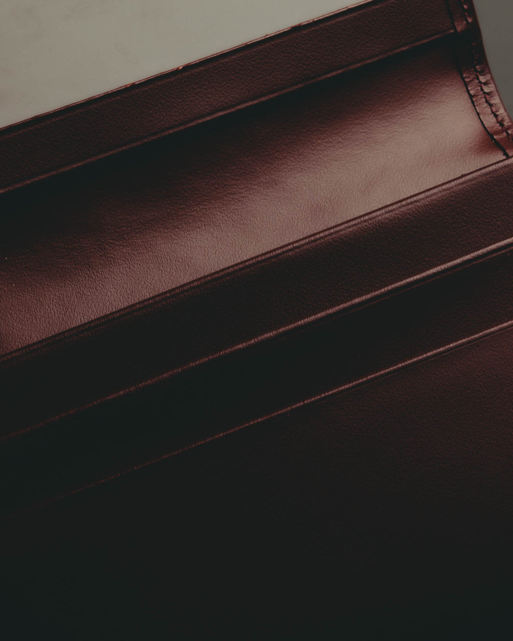“Cartier” 90’s Must de Cartier burgundy embossed leather bifold wallet
