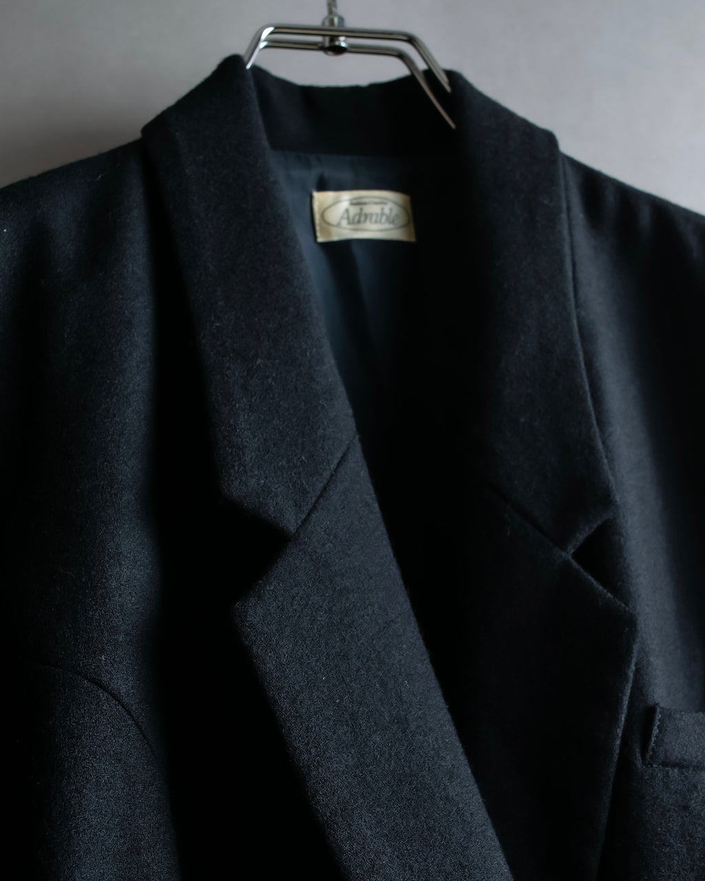 Tight-waisted wool shirt and black coat