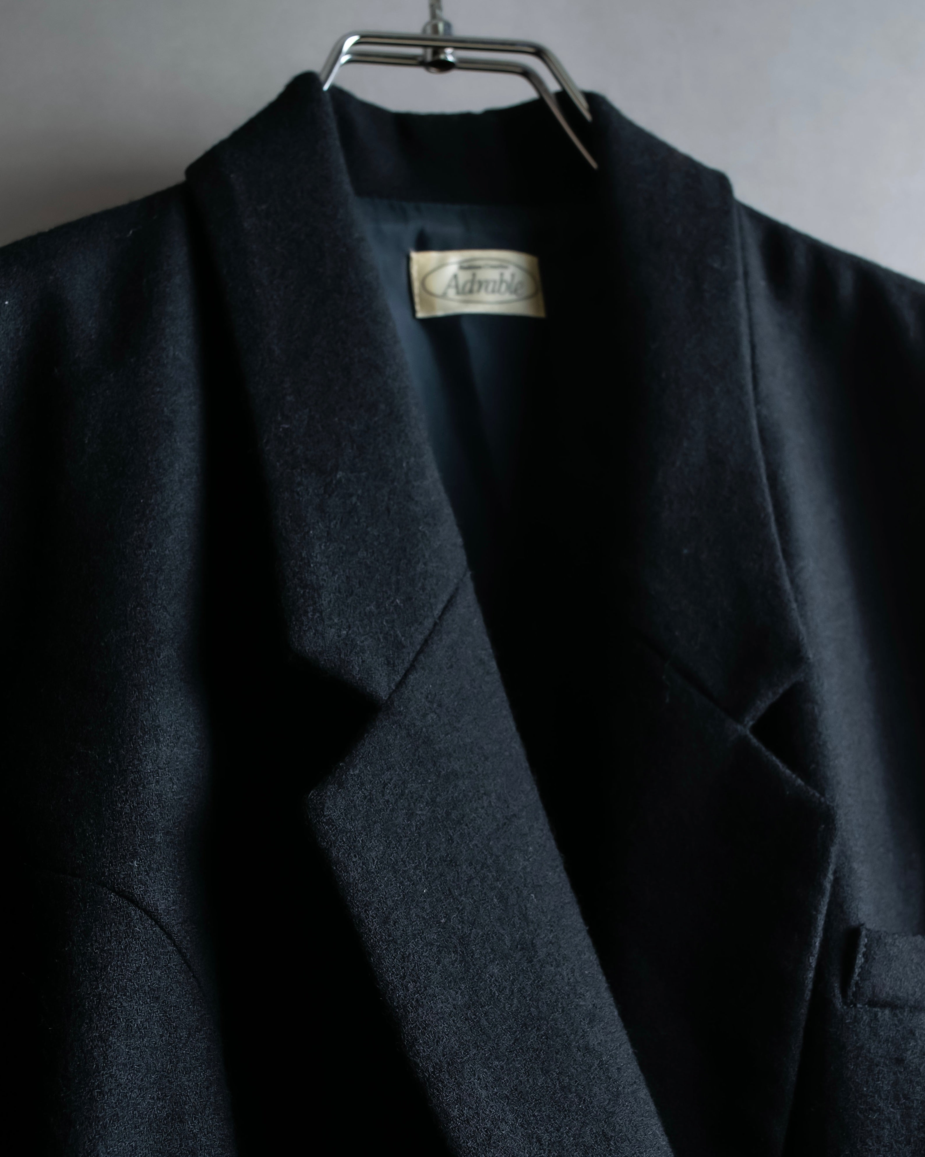 Tight-waisted wool shirt and black coat