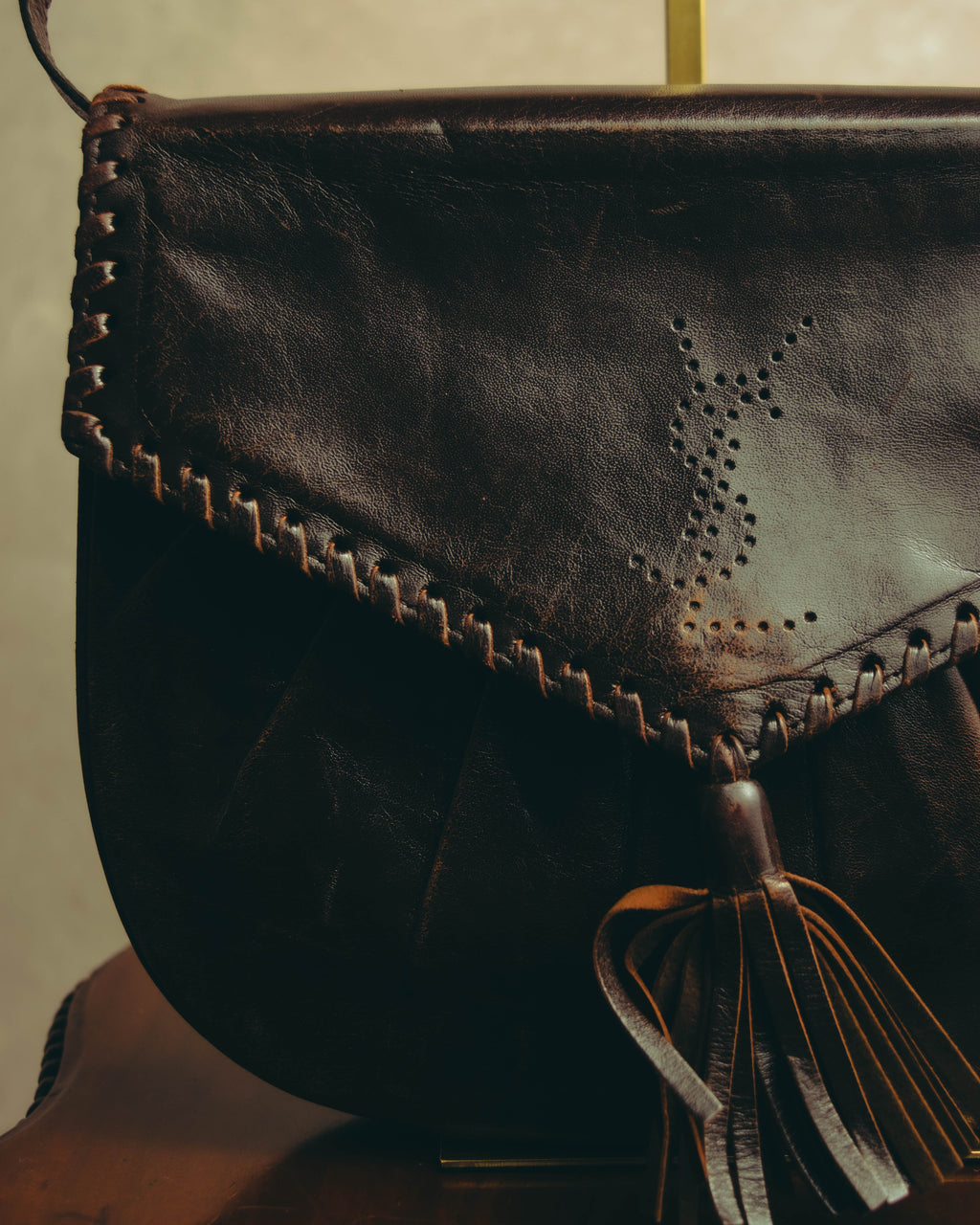 “Yves Saint Laurent” 70’s-80’s Perforated logo leather tassel shoulder bag