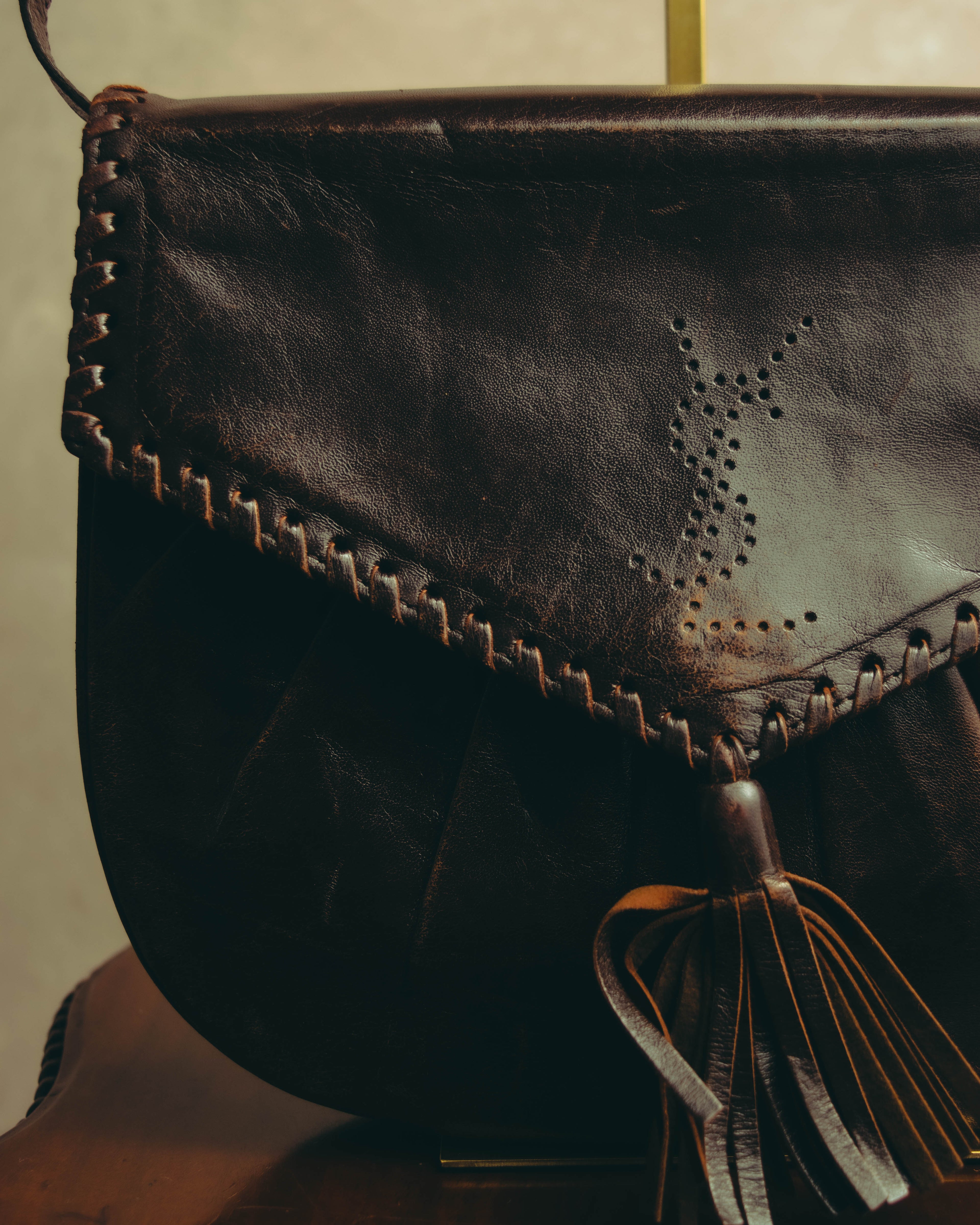“Yves Saint Laurent” 70’s-80’s Perforated logo leather tassel shoulder bag