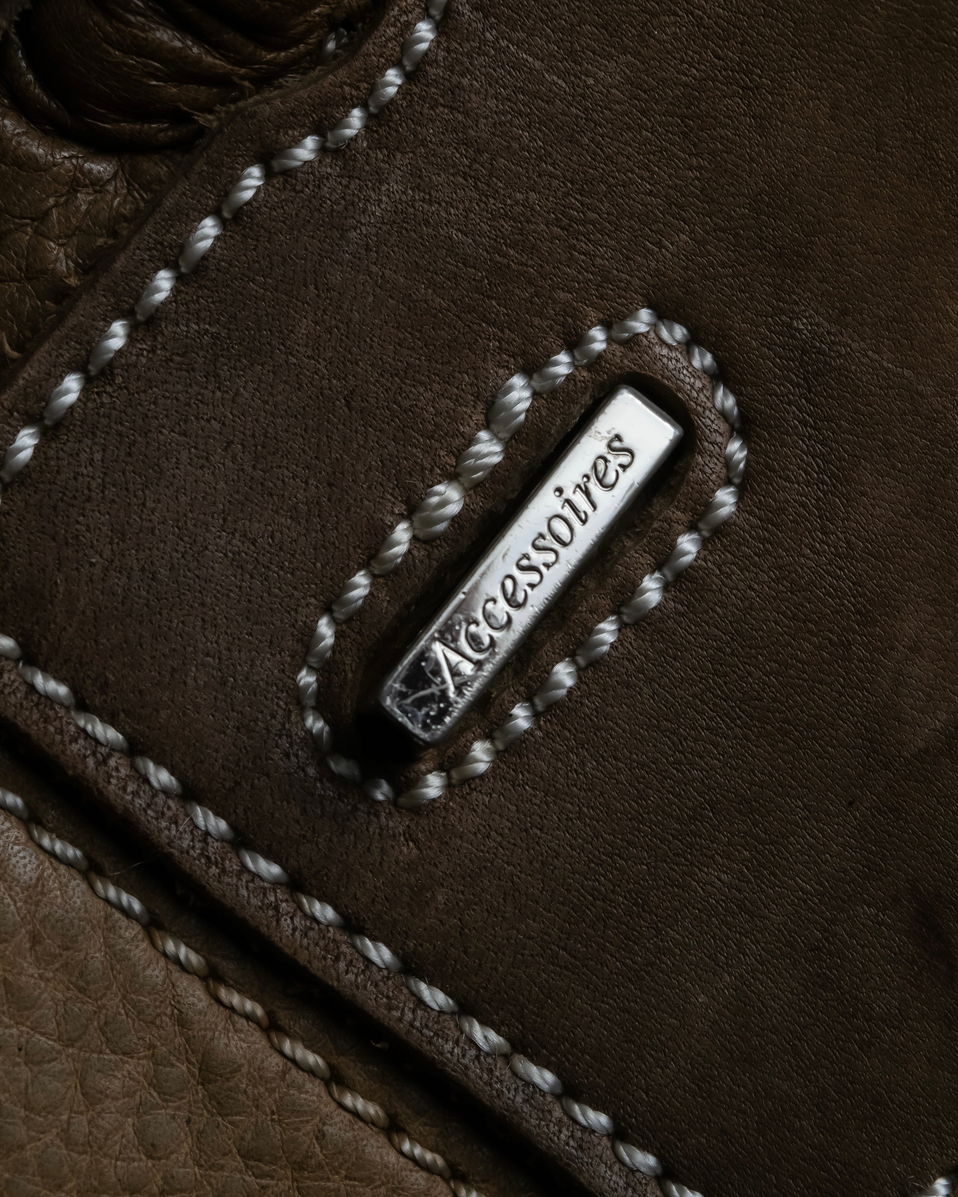 "Mademoiselle Accessories"
 Silver parts design leather one handle bag