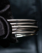 “PHILIPPE AUDIBERT” Crossed 5 line silver bangle