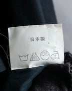 Tight-waisted wool shirt and black coat