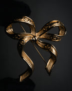 “Christian Dior“ 80’s-90’s CD-embossed ribbon brooch