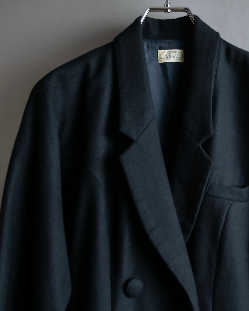 Tight-waisted wool shirt and black coat