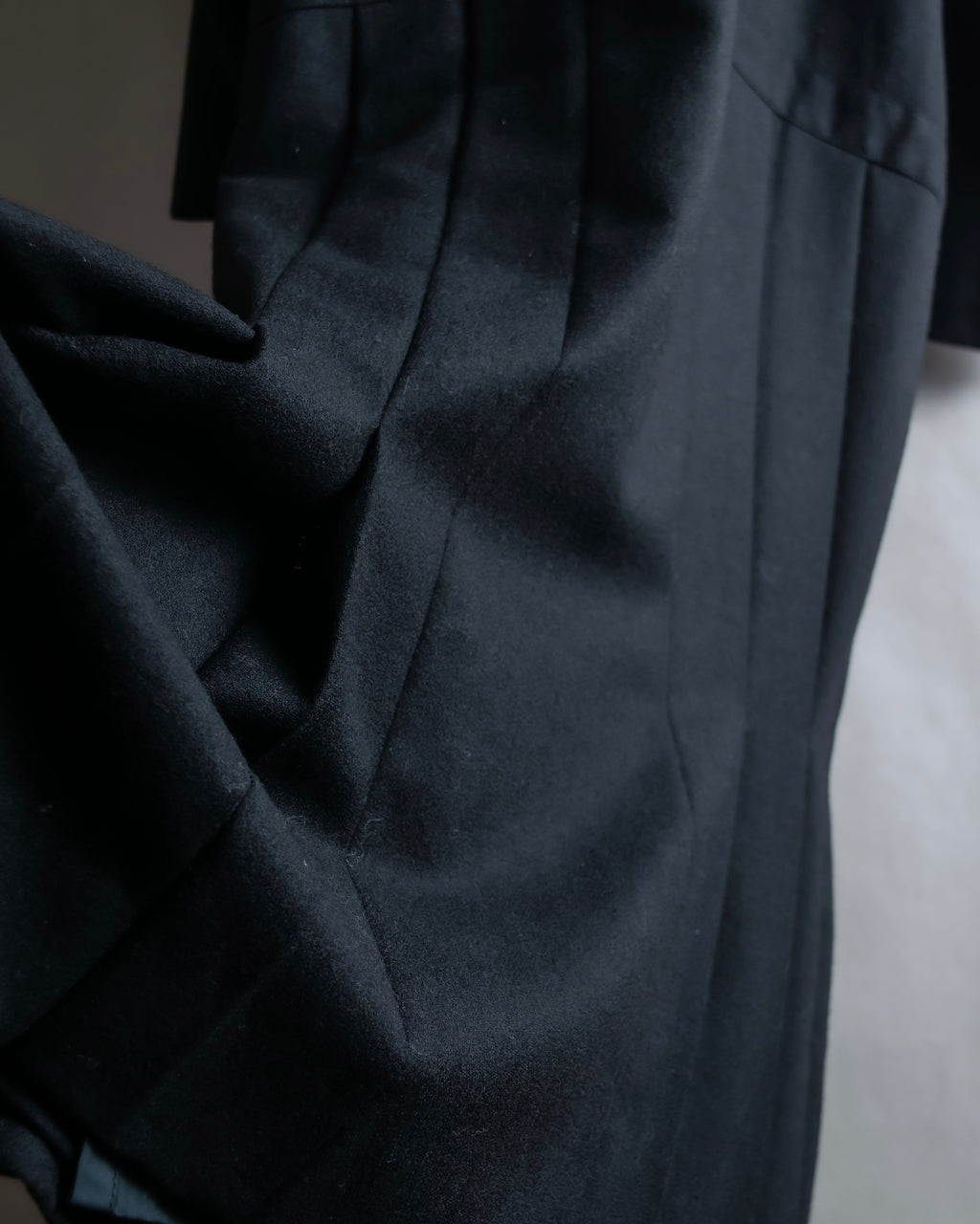 Tight-waisted wool shirt and black coat