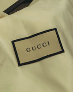 参考付属品として揃う、GUCCIロゴ入りダストバッグのタグ部分。生成りの布地に黒縁の織りネームが配されています。