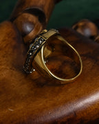 "Alexandar McQueen" Horseshoe motif red stone top ring