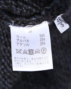 ウール50％・アルパカ25％・アクリル25％の混率とケア表示を確認できる内側の素材・洗濯表示タグ。サイズ表記は48／S。