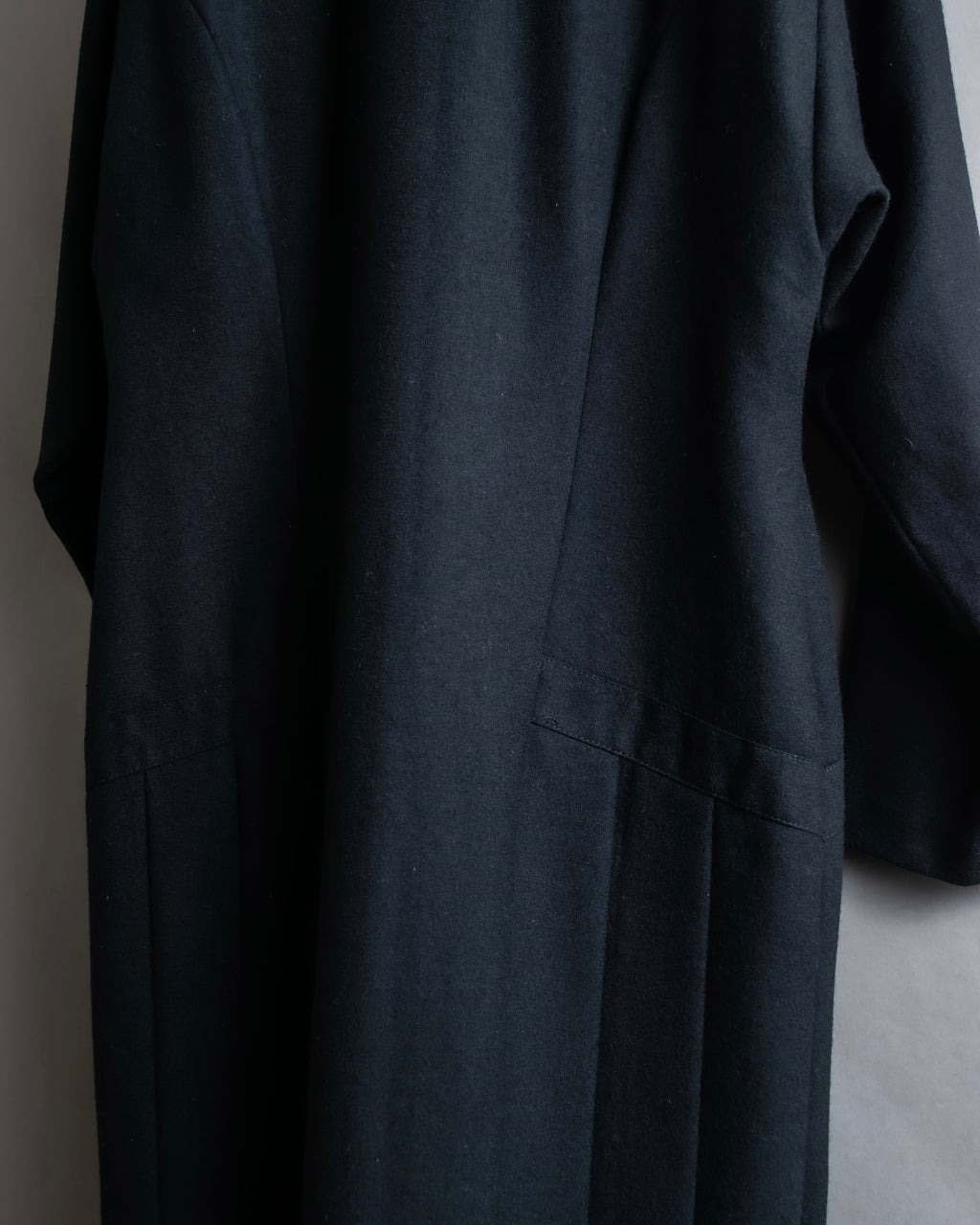 Tight-waisted wool shirt and black coat