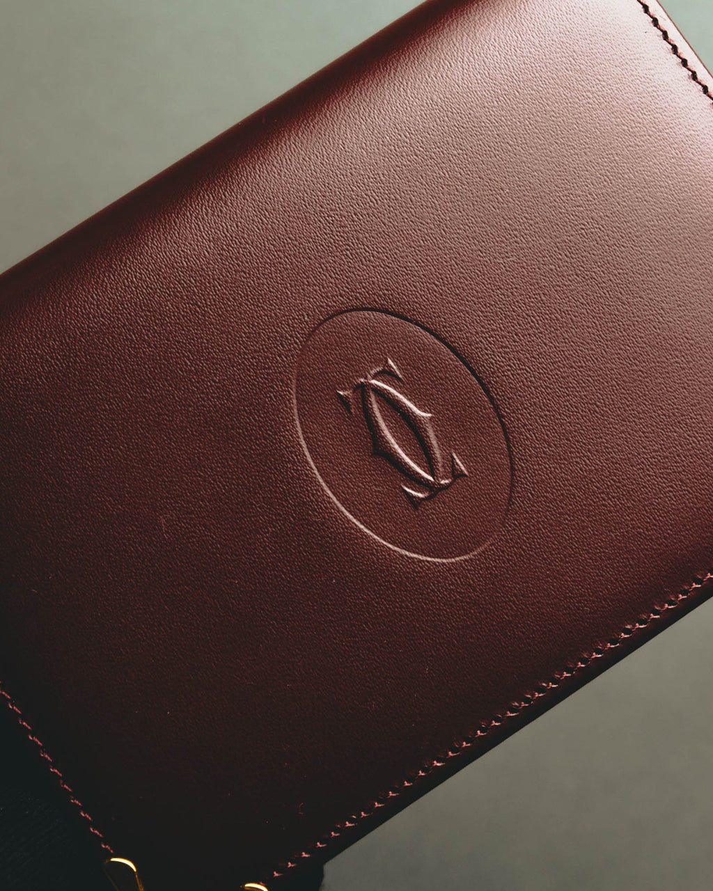 “Cartier” 90’s Must de Cartier burgundy embossed leather bifold wallet