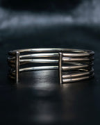 “PHILIPPE AUDIBERT” Crossed 5 line silver bangle