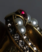 "Alexandar McQueen" Horseshoe motif red stone top ring