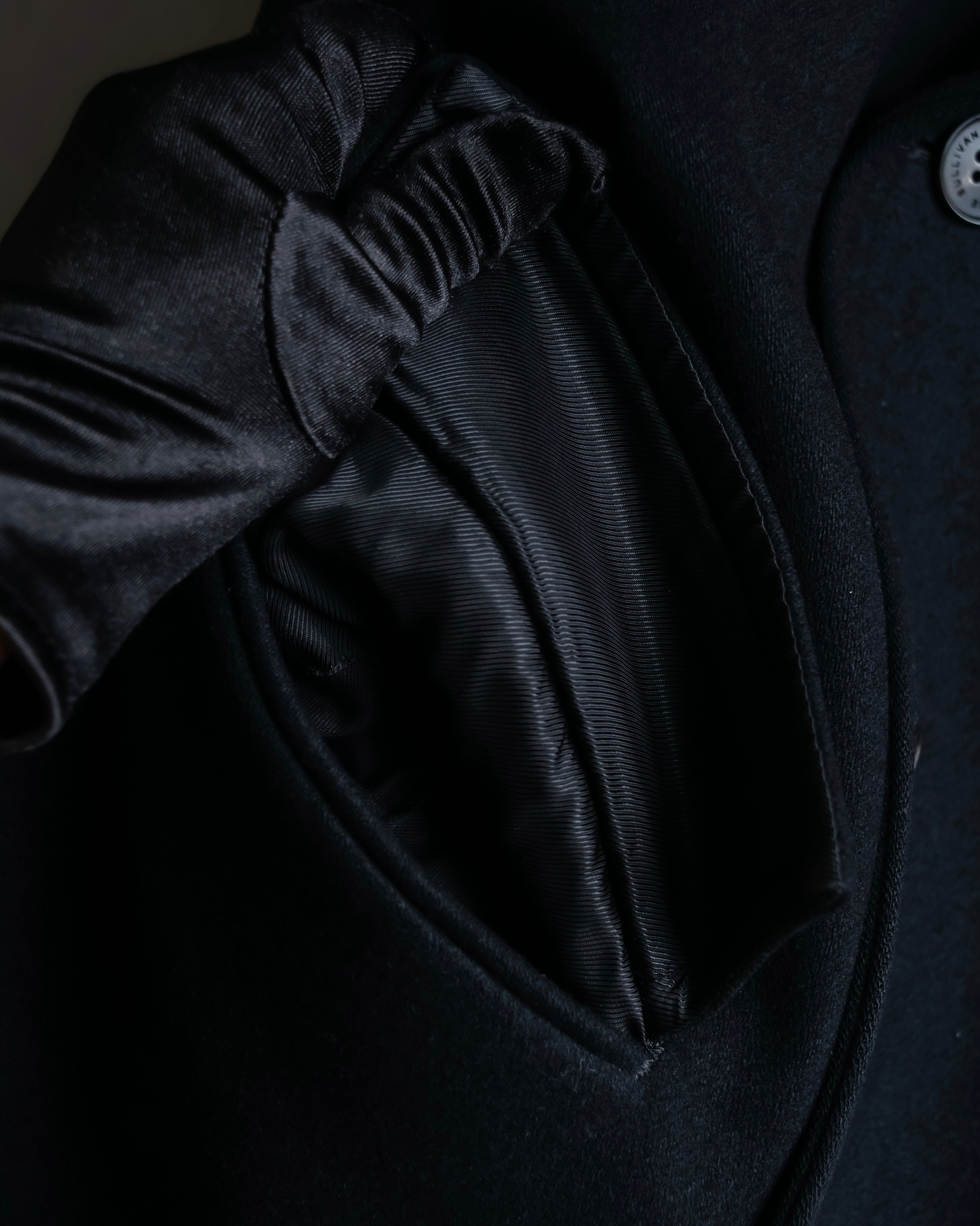 "JOHN LAWRENCE SULLIVAN"
 Large lapel double-breasted mid length coat