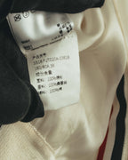 製品コード「SS18FJT020A-03618」とサイズ表記を確認できる品質表示タグのカット。表地ナイロン100%、裏地シルク100%、補料コットン100%の素材表記が写っています。