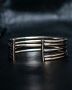 “PHILIPPE AUDIBERT” Crossed 5 line silver bangle