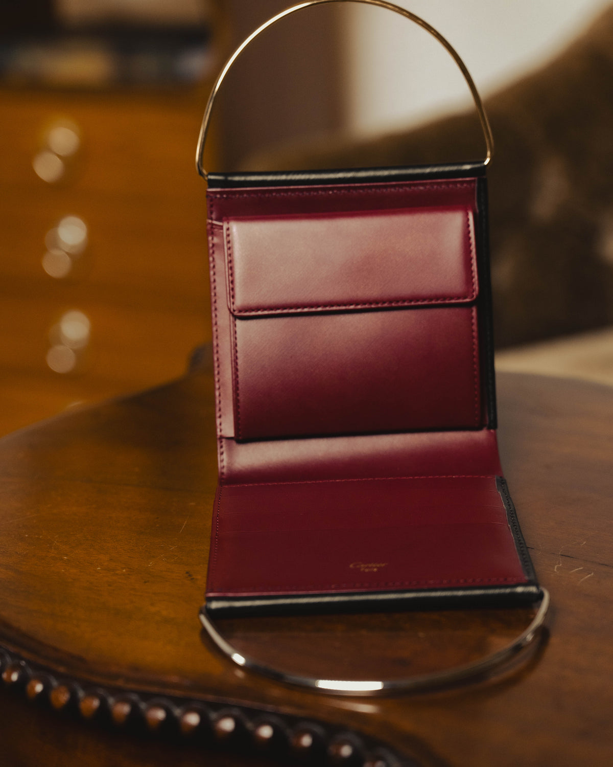 "Cartier" 80's Sculptural ring-handle leather wallet