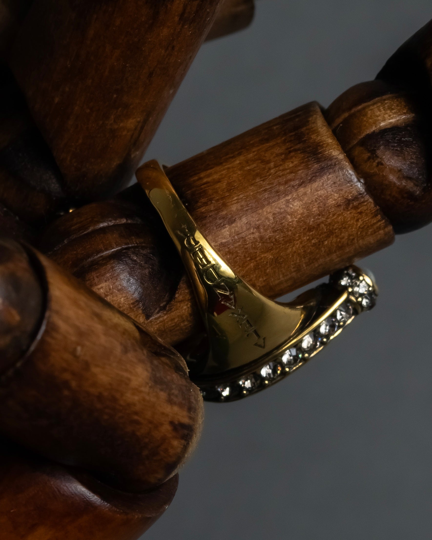 "Alexandar McQueen" Horseshoe motif red stone top ring