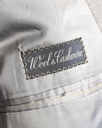 滑らかなグレー系の総裏地に配された「Wool & Cashmere」表記の服地ネーム。内ポケットまわりの袋布とパイピングの仕様も確認できる内側のカット。