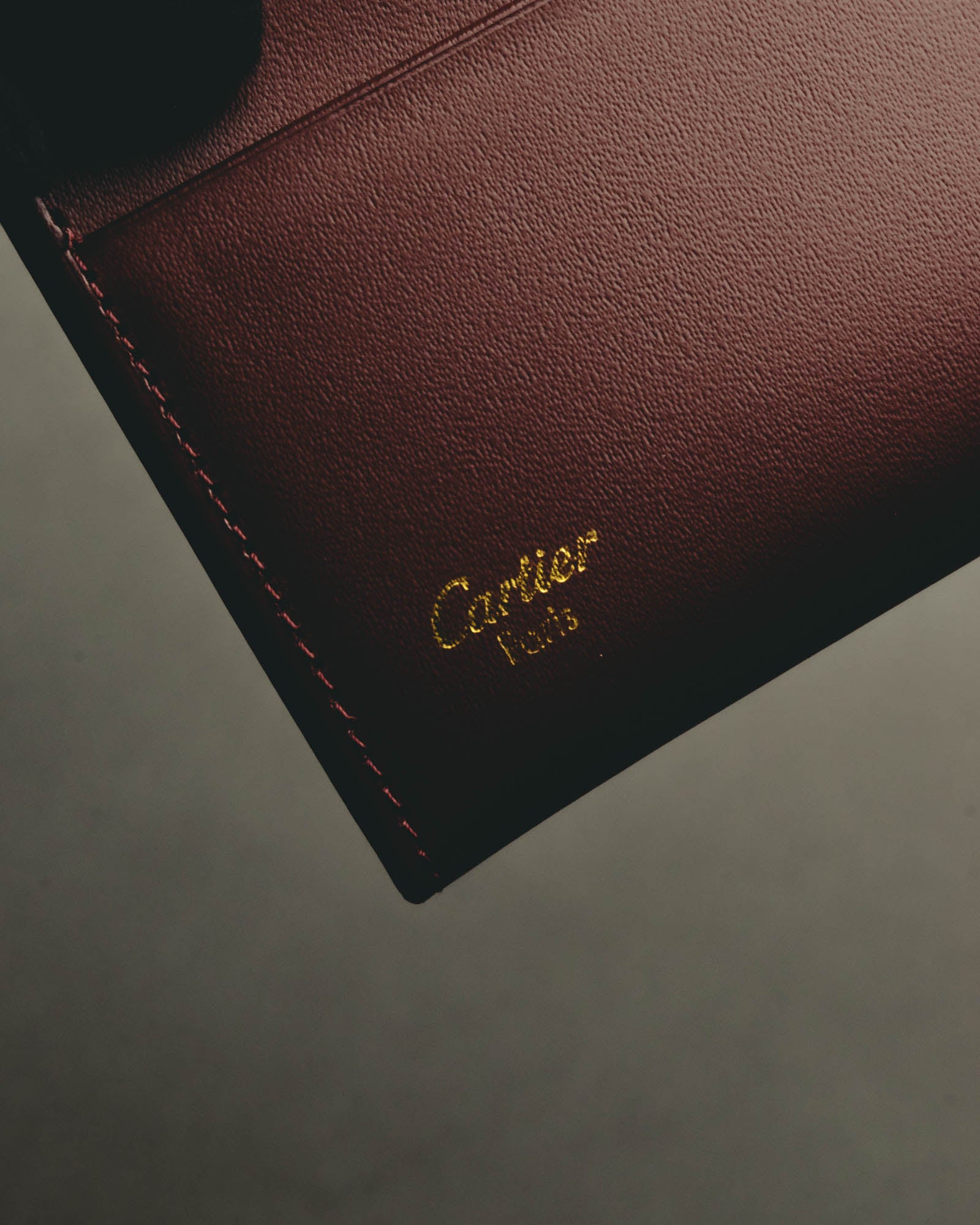 “Cartier” 90’s Must de Cartier burgundy embossed leather bifold wallet