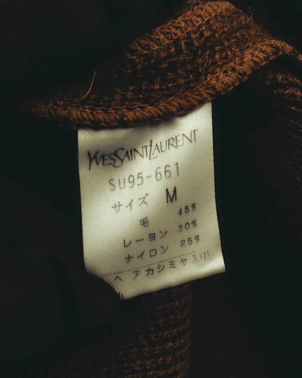 Yves Saint Laurentのブランドタグと、福助株式会社表記を含む国内向け品質表示のカット。サイズM、毛・レーヨン・ナイロンの混紡素材表記が確認できます。