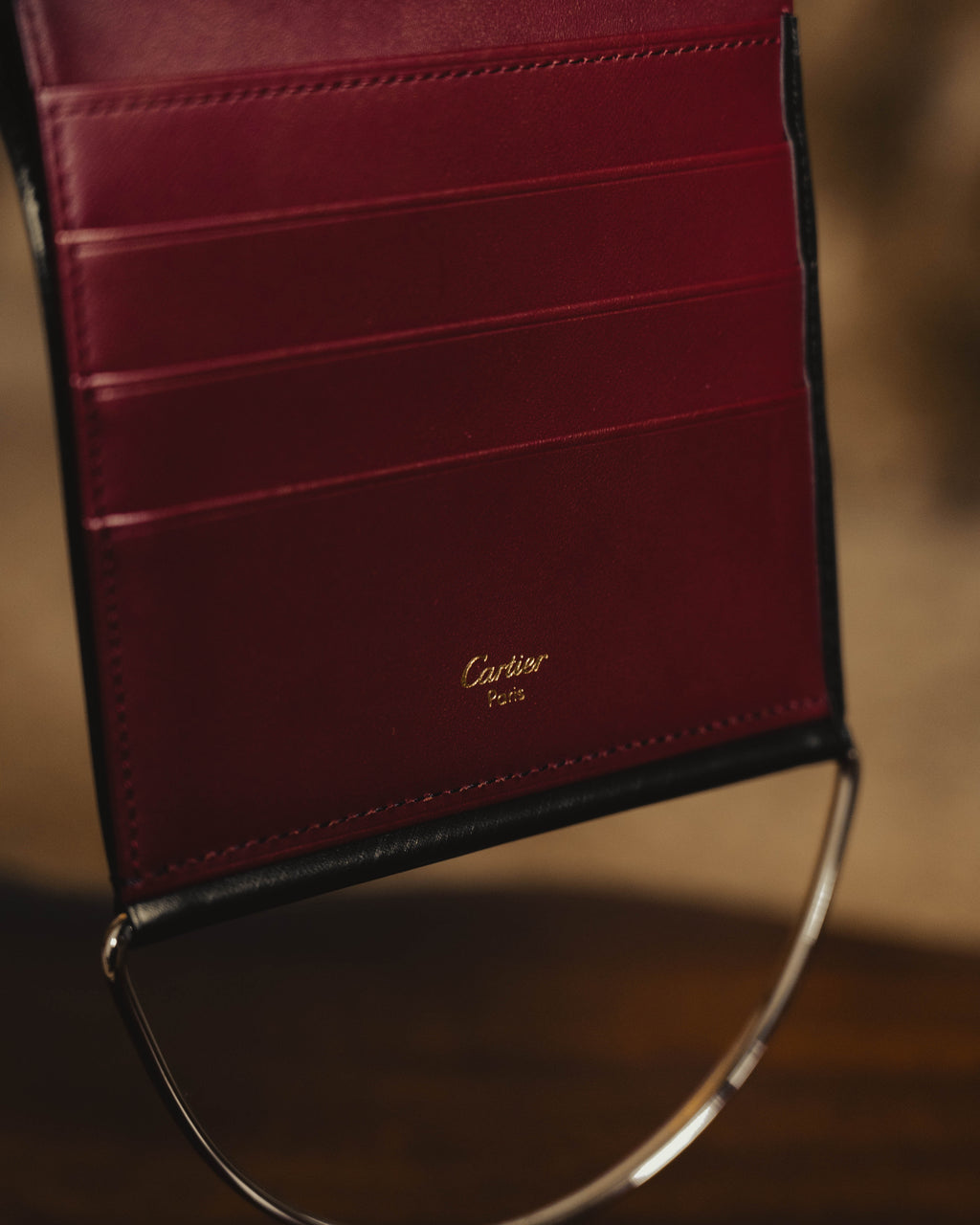 "Cartier" 80's Sculptural ring-handle leather wallet